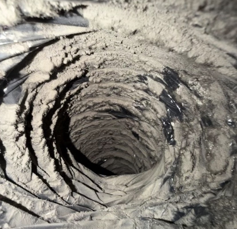 Inside of a flexible air duct coated with heavy dust buildup